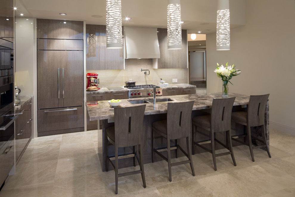 Design ideas for a mid-sized contemporary l-shaped eat-in kitchen in Calgary with an undermount sink, flat-panel cabinets, grey cabinets, onyx benchtops, beige splashback, stainless steel appliances, travertine floors, with island, beige floor and brown benchtop.