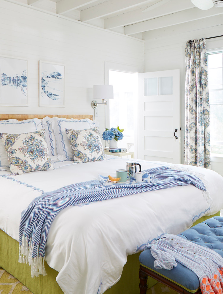 Photo of a mid-sized beach style master bedroom in Portland Maine with white walls.