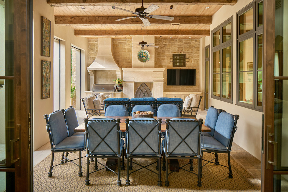 Large tuscan backyard tile patio photo in Austin with a roof extension and a bbq area