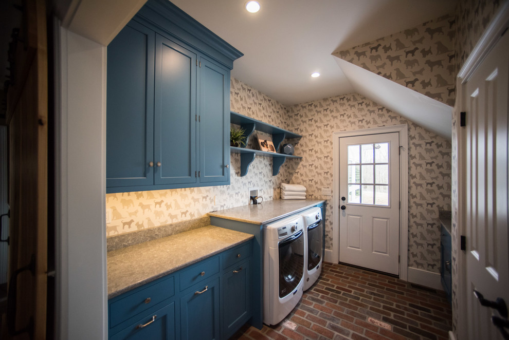 Photo of a country laundry room in Philadelphia with an undermount sink, blue cabinets, quartz benchtops, brick floors, a side-by-side washer and dryer and beige benchtop.