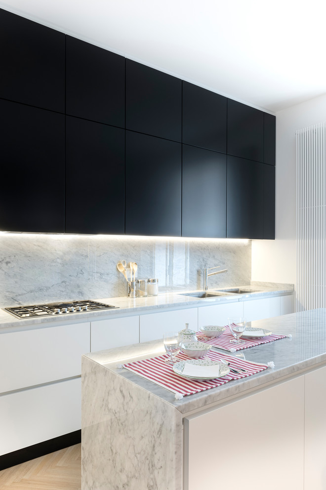 Design ideas for a contemporary galley kitchen in Other with an undermount sink, flat-panel cabinets, white cabinets, marble benchtops, grey splashback, marble splashback, panelled appliances, light hardwood floors, with island, beige floor and grey benchtop.