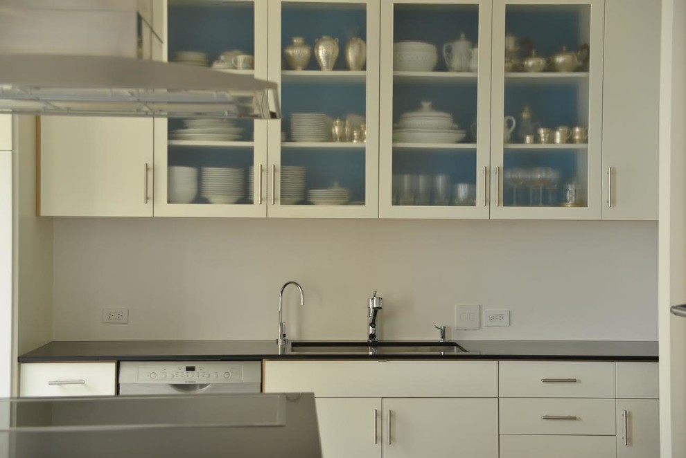 Example of a large trendy l-shaped ceramic tile eat-in kitchen design in Orange County with white cabinets, stainless steel appliances and an island