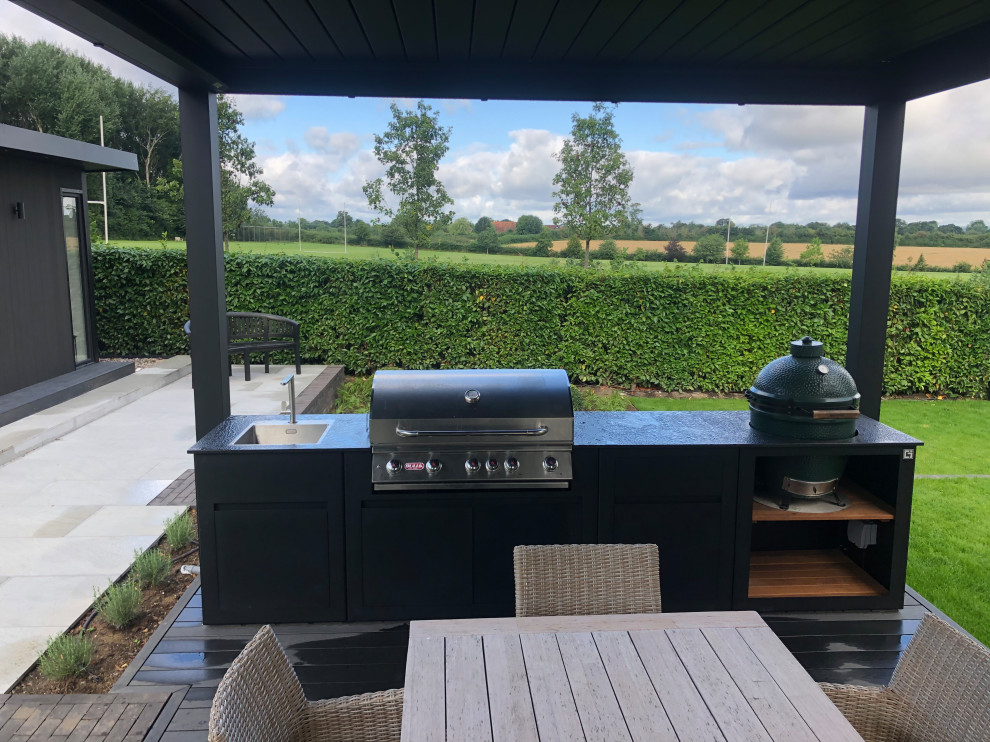 Design ideas for a contemporary back terrace in Hertfordshire with a bbq area.