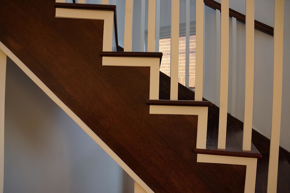 Staircase - large wooden curved staircase idea in Denver with wooden risers