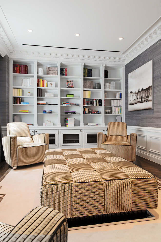 This is an example of a contemporary family room in Montreal with a library, grey walls and dark hardwood floors.