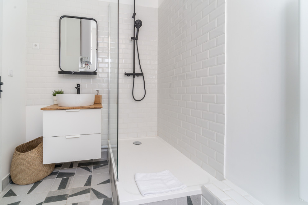 Photo of a contemporary 3/4 bathroom in Paris with flat-panel cabinets, white cabinets, a corner shower, white tile, subway tile, white walls, a vessel sink, wood benchtops, multi-coloured floor, an open shower, brown benchtops, a single vanity and a floating vanity.