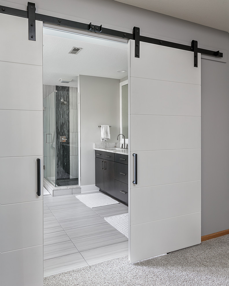 Photo of a mid-sized modern master bathroom in Other with flat-panel cabinets, dark wood cabinets, a freestanding tub, an open shower, a two-piece toilet, ceramic floors, an undermount sink, quartzite benchtops, grey floor and a hinged shower door.