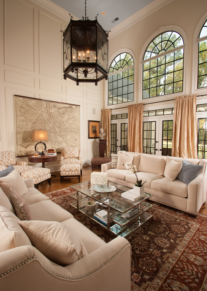 Large elegant formal medium tone wood floor and brown floor living room photo in Atlanta with beige walls