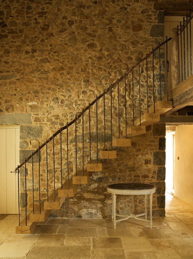 Country wood straight staircase in Channel Islands with open risers.