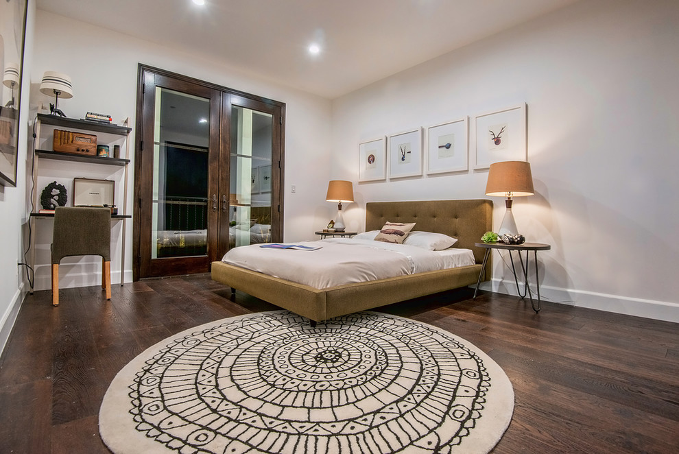 This is an example of a large transitional master bedroom in San Francisco with white walls, dark hardwood floors and no fireplace.