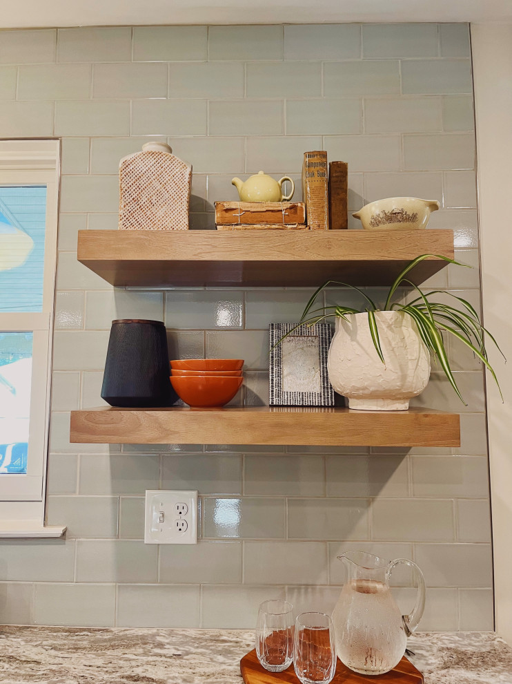 Example of a mid-sized transitional l-shaped vinyl floor and beige floor eat-in kitchen design with a farmhouse sink, shaker cabinets, medium tone wood cabinets, quartzite countertops, green backsplash, ceramic backsplash, stainless steel appliances, no island and beige countertops