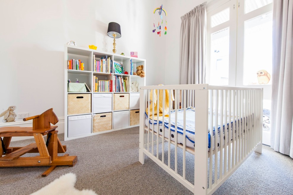 Photo of a mid-sized contemporary gender-neutral nursery in Melbourne with white walls, carpet and grey floor.