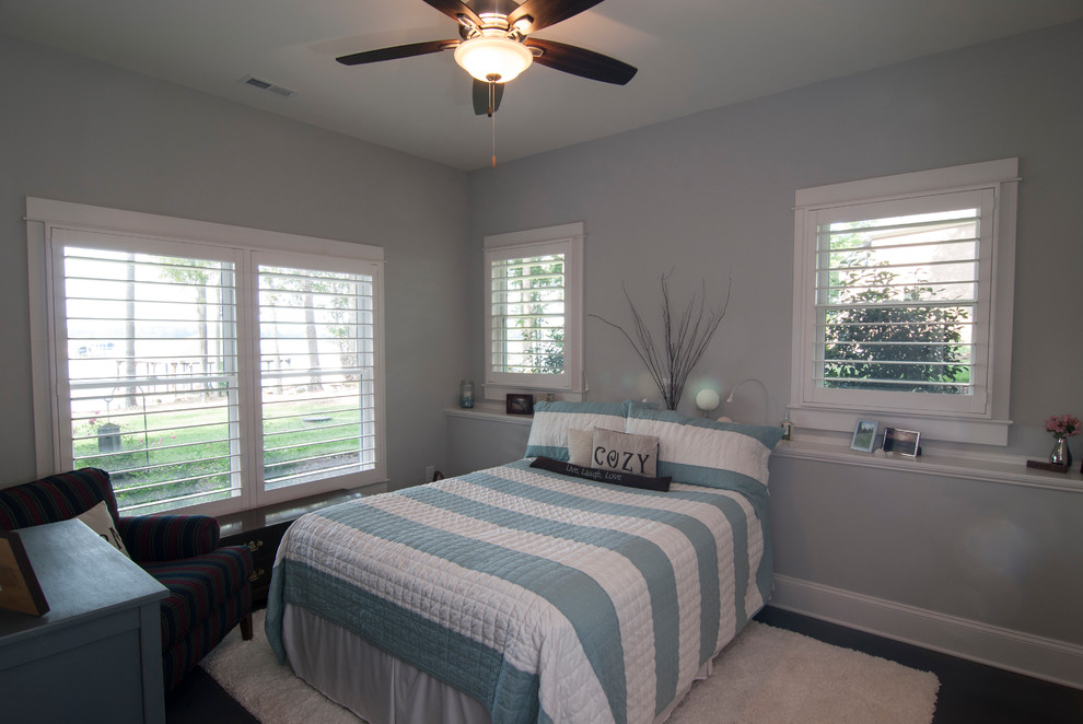 This is an example of a mid-sized transitional guest bedroom in Charlotte with grey walls, dark hardwood floors, no fireplace and brown floor.