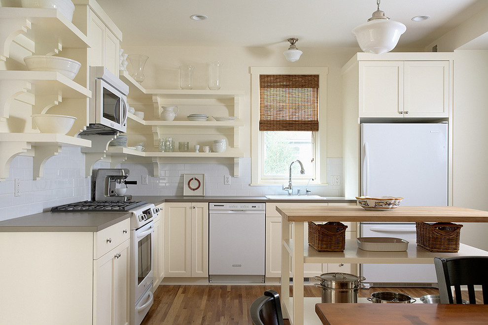 This is an example of a traditional kitchen in Minneapolis with laminate benchtops, white appliances and open cabinets.