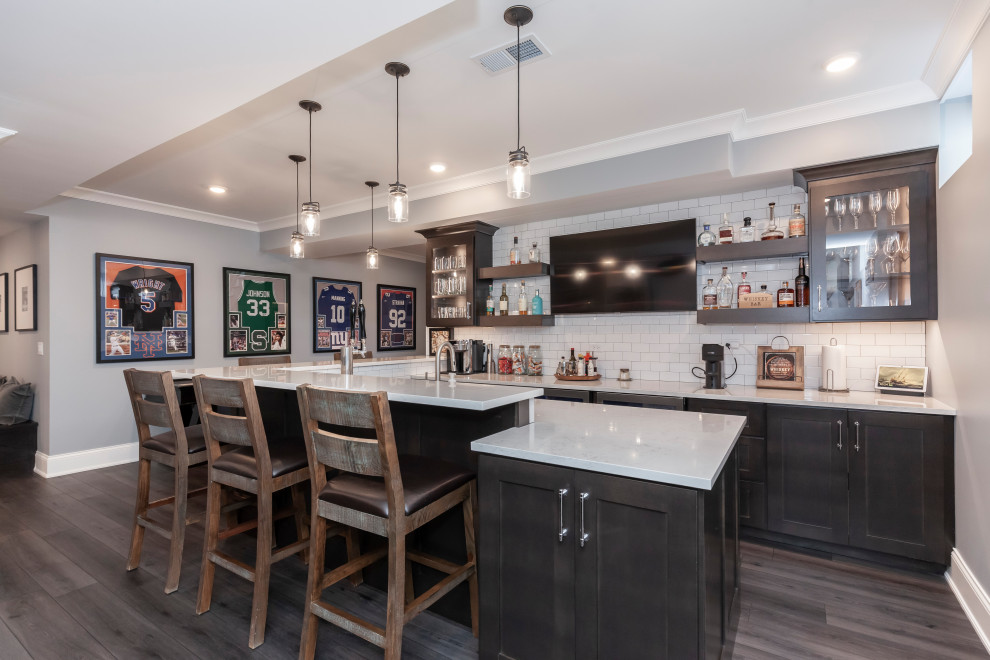 Photo of a farmhouse home bar in Chicago with vinyl flooring and brown floors.