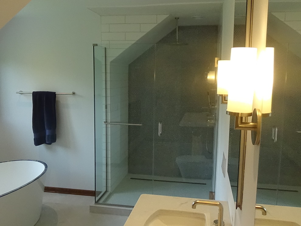 Example of a mid-sized transitional master white tile and ceramic tile porcelain tile and beige floor freestanding bathtub design in Chicago with recessed-panel cabinets, medium tone wood cabinets, a wall-mount toilet, white walls, an undermount sink, quartz countertops, a hinged shower door and white countertops