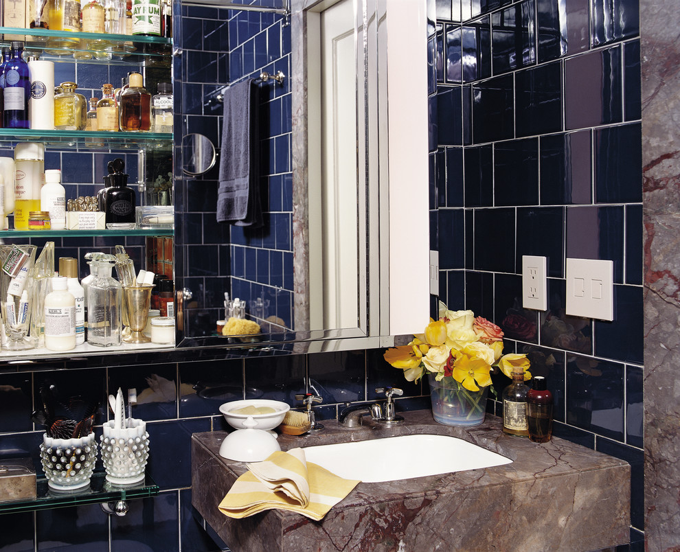 This is an example of a modern bathroom in New York with an undermount sink and blue tile.