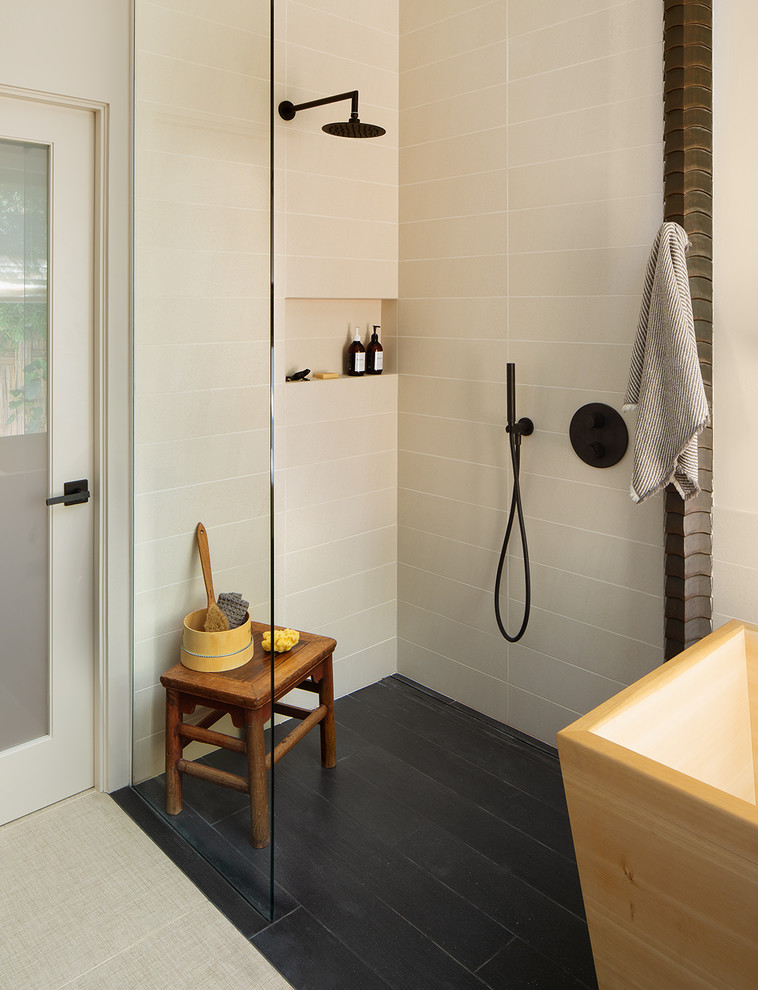 Photo of a large asian master bathroom in San Diego with flat-panel cabinets, medium wood cabinets, a japanese tub, a curbless shower, a two-piece toilet, white tile, porcelain floors, an undermount sink, solid surface benchtops, beige floor, white benchtops, vaulted, an open shower, a double vanity and a floating vanity.