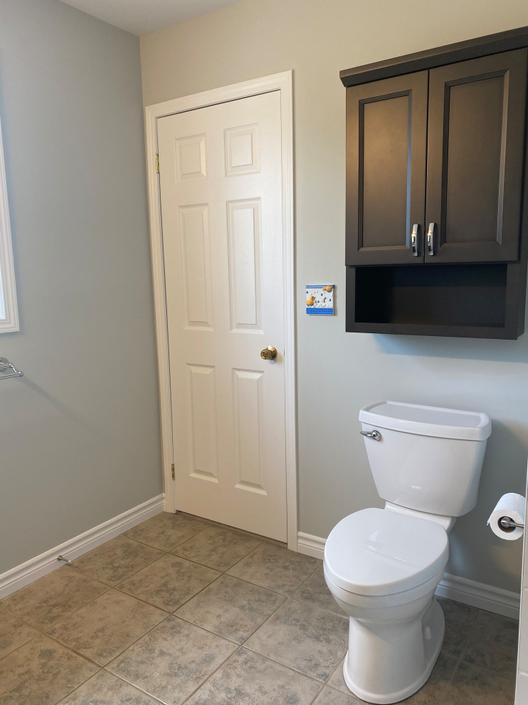 Inspiration for a transitional 3/4 porcelain tile, gray floor and single-sink bathroom remodel with recessed-panel cabinets, a one-piece toilet, gray walls, an undermount sink, quartzite countertops, white countertops and a built-in vanity