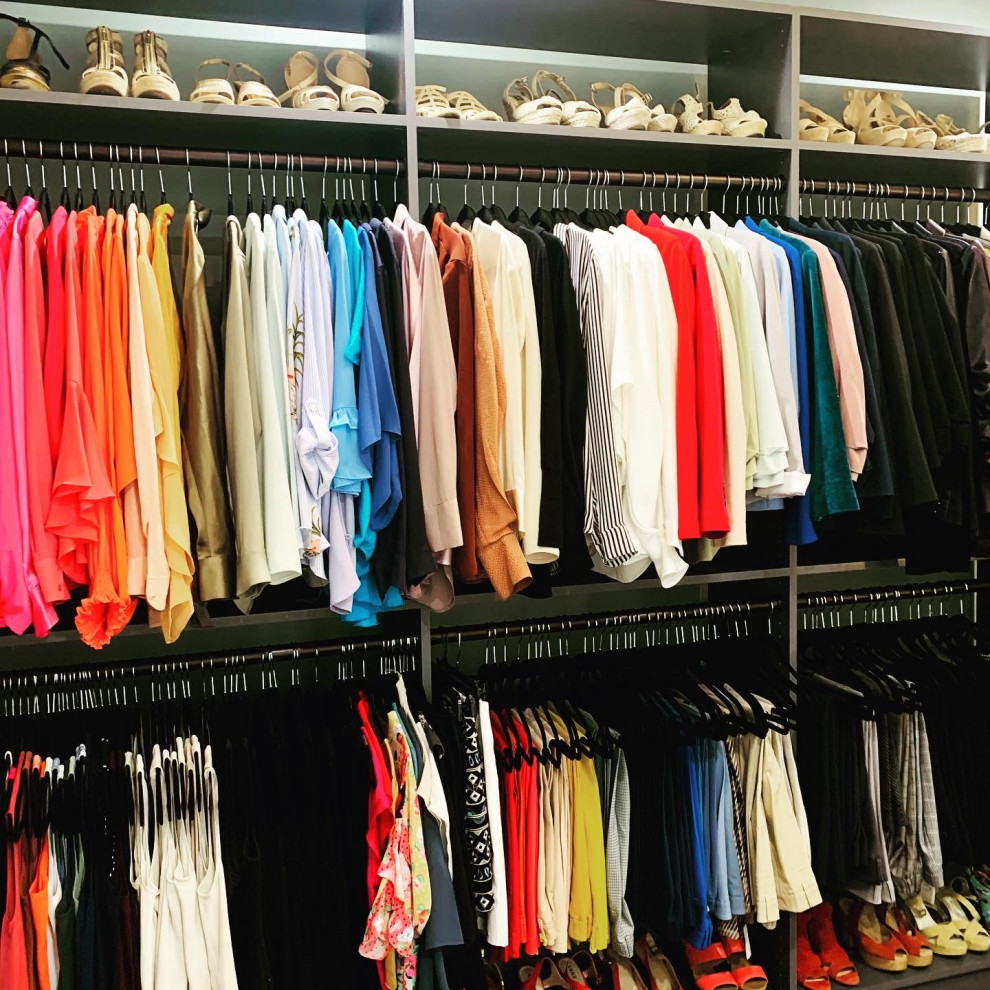 Design ideas for a mid-sized modern women's walk-in wardrobe in Dallas with grey cabinets.