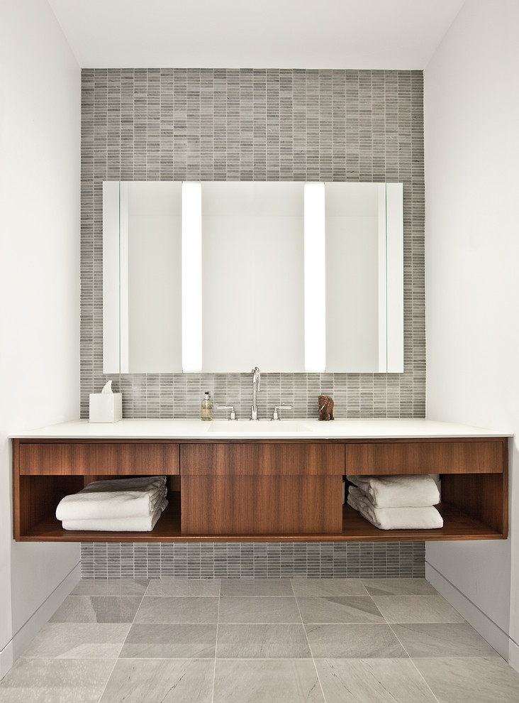 Inspiration for an industrial bathroom in Chicago with open cabinets, dark wood cabinets and gray tile.