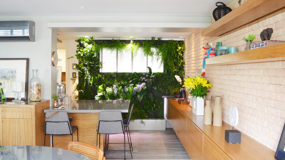 This is an example of a small modern separate dining room in Miami with green walls and grey floor.