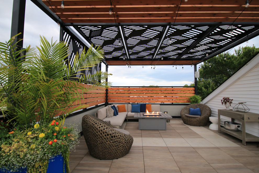 Inspiration for a small contemporary privacy and wood railing deck remodel in Chicago with a pergola