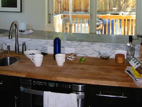 Inspiration for a transitional kitchen remodel in Salt Lake City with an undermount sink, black cabinets, wood countertops and stainless steel appliances