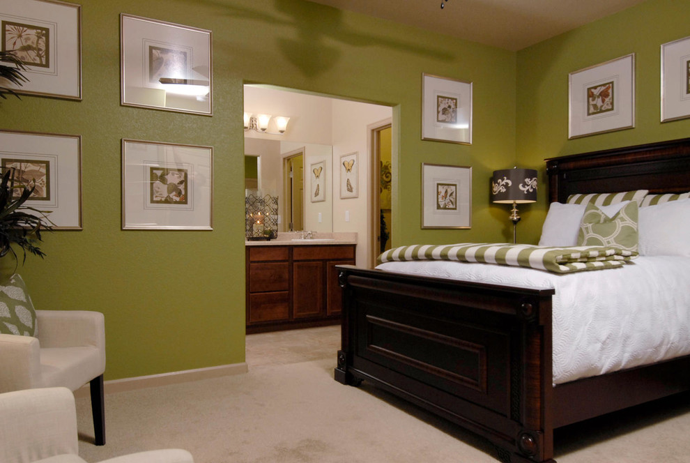 Traditional master bedroom in Denver with green walls and carpet.