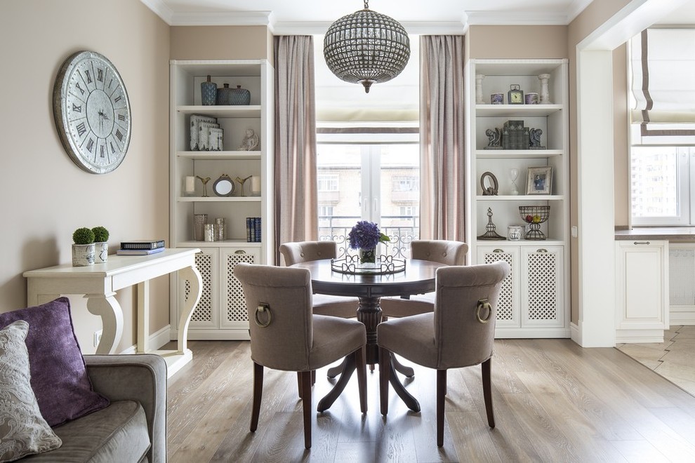 Transitional open plan dining in Moscow with beige walls and light hardwood floors.