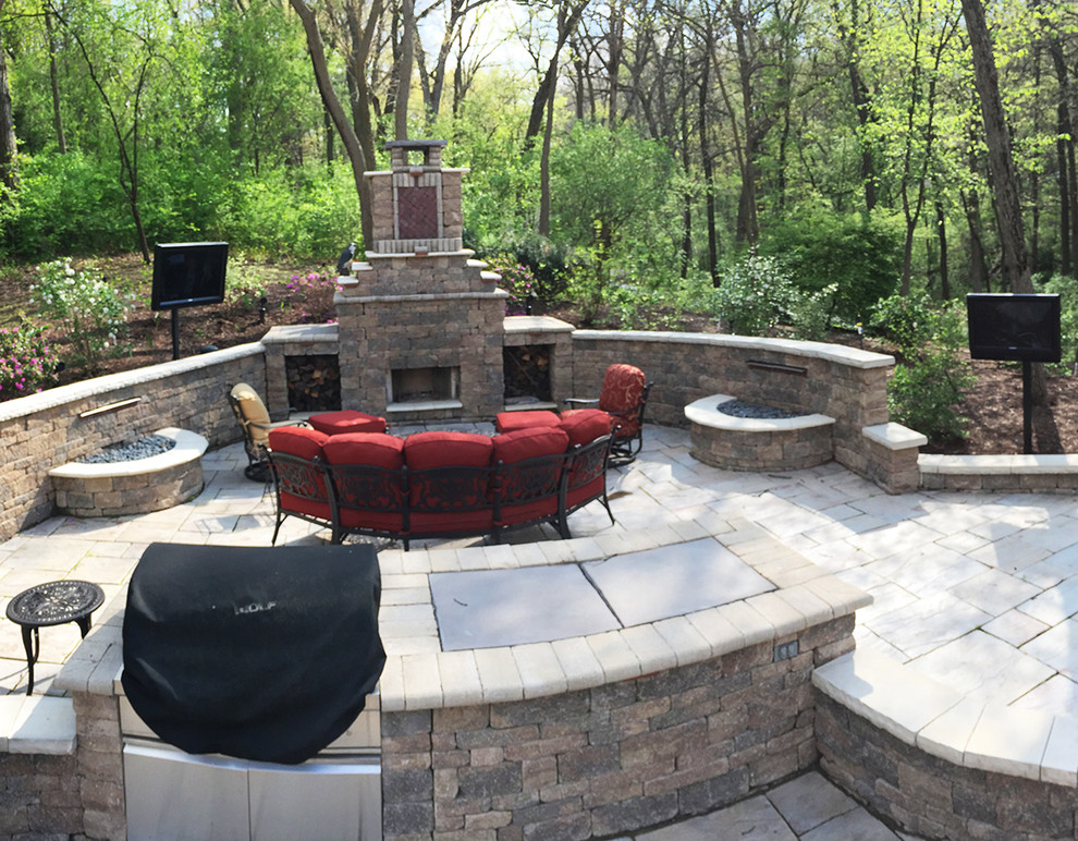 Large contemporary backyard patio in Chicago with a fire feature, natural stone pavers and no cover.