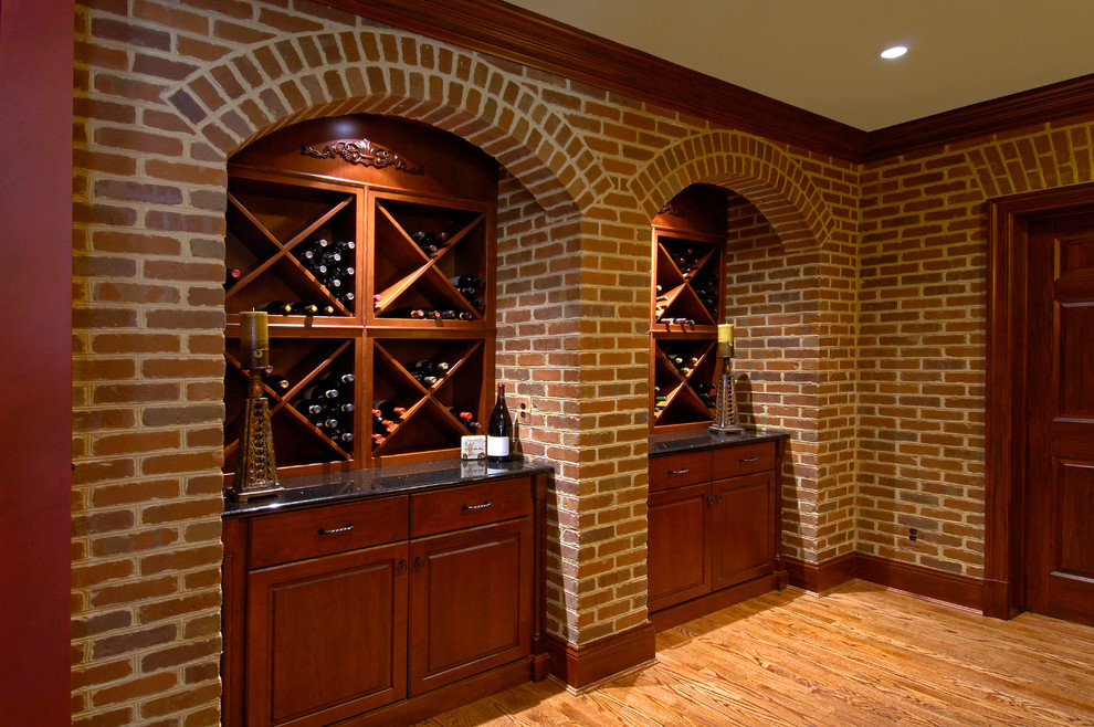 Photo of a large traditional wine cellar in DC Metro with brick floors and diamond bins.