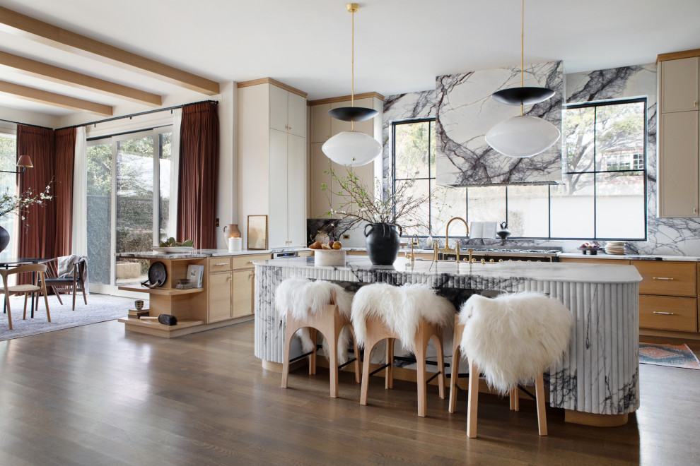 Mid-sized trendy u-shaped medium tone wood floor and beige floor enclosed kitchen photo in Dallas with an undermount sink, flat-panel cabinets, medium tone wood cabinets, white backsplash, stainless steel appliances, an island, white countertops, marble countertops and marble backsplash