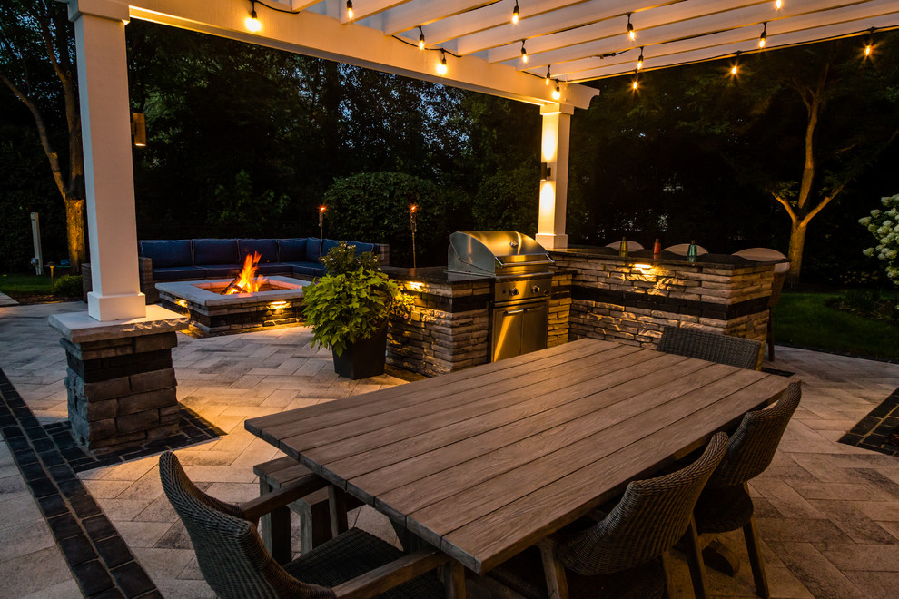 Design ideas for a large contemporary backyard patio in Chicago with a fire feature, concrete pavers and a pergola.