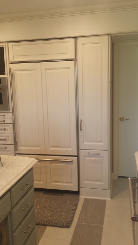 Small transitional u-shaped ceramic tile eat-in kitchen photo with a double-bowl sink, raised-panel cabinets, white cabinets, marble countertops, white backsplash, subway tile backsplash, stainless steel appliances and an island