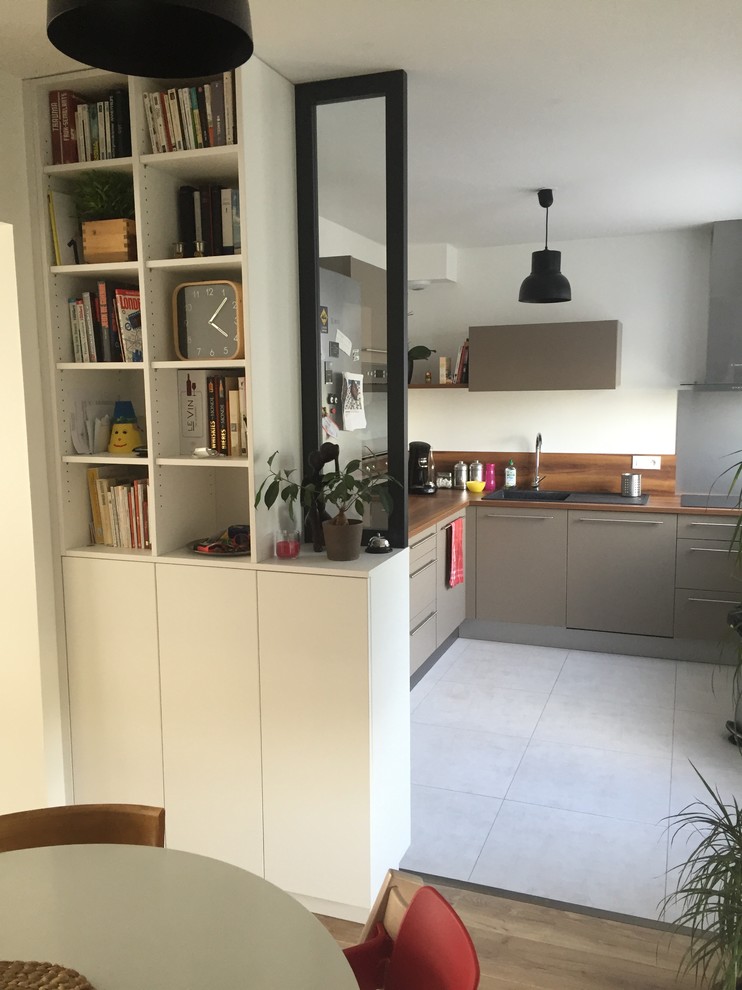 This is an example of a mid-sized contemporary kitchen/dining combo in Angers with white walls, ceramic floors and no fireplace.