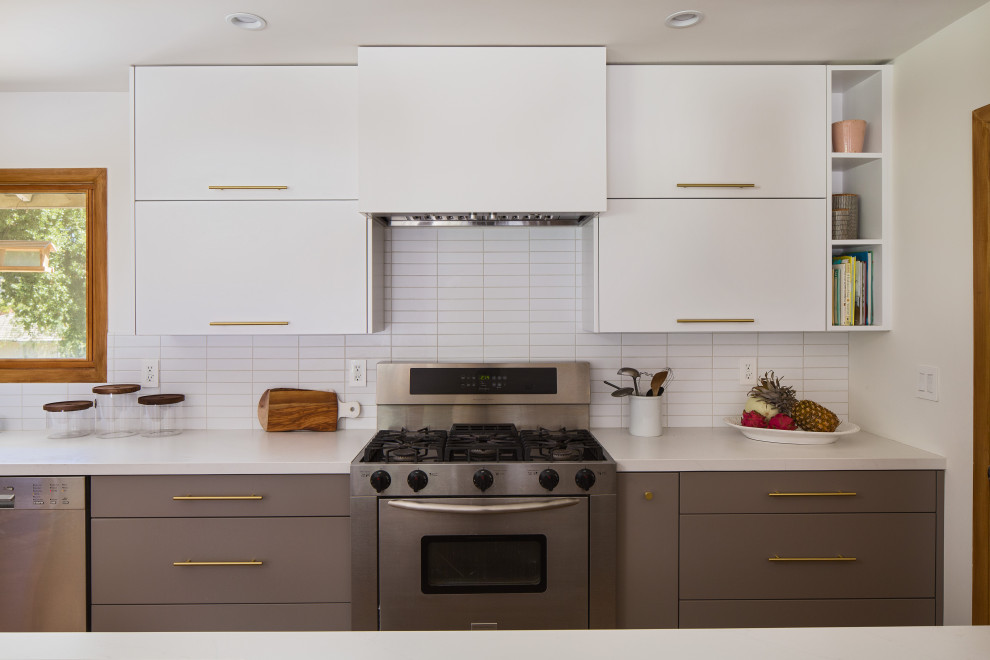 Inspiration for an expansive scandinavian galley eat-in kitchen in Los Angeles with an undermount sink, flat-panel cabinets, grey cabinets, quartz benchtops, white splashback, subway tile splashback, stainless steel appliances, bamboo floors, a peninsula, yellow floor and white benchtop.