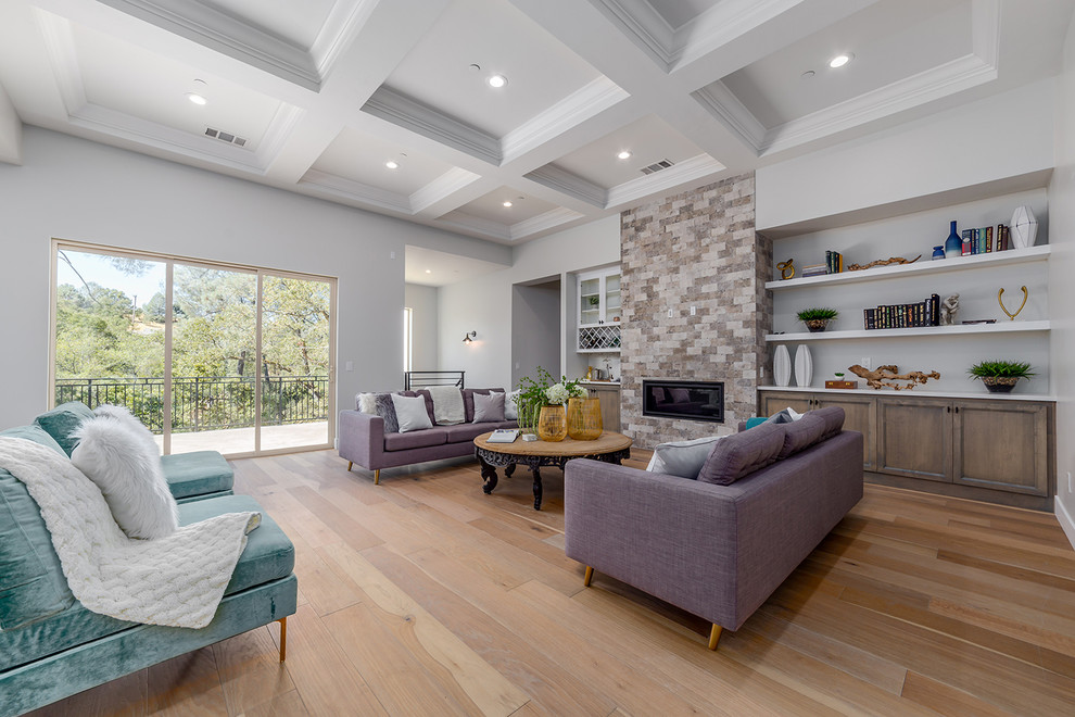 Large country open concept living room in Sacramento with grey walls, light hardwood floors, a stone fireplace surround, beige floor, a home bar and a ribbon fireplace.