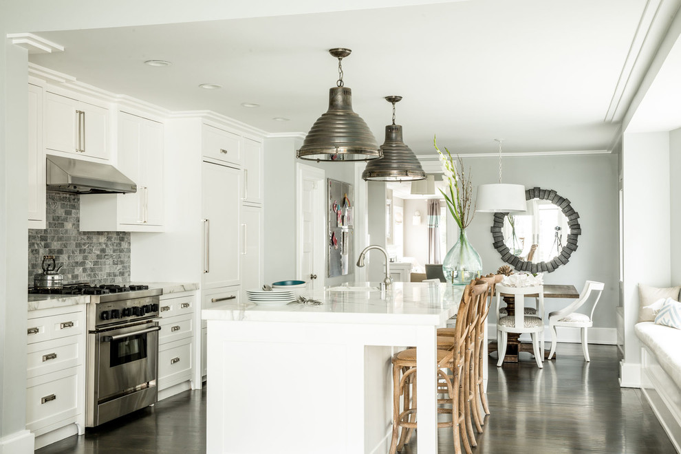 Inspiration for a beach style kitchen in San Francisco with an undermount sink, white cabinets, marble benchtops, grey splashback, stainless steel appliances, dark hardwood floors, with island and shaker cabinets.