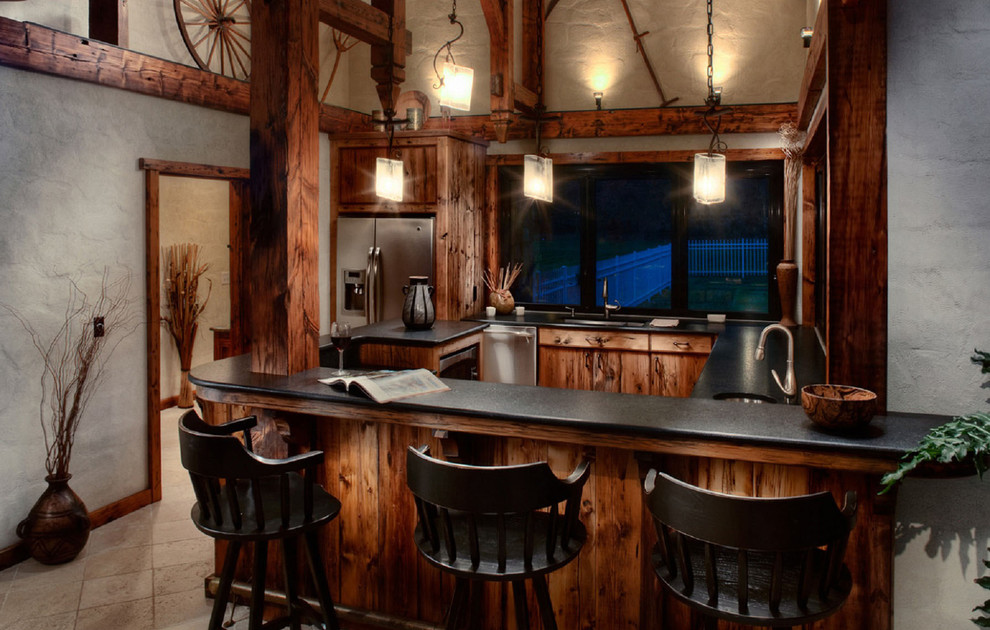 Inspiration for a large arts and crafts u-shaped seated home bar in New York with an undermount sink, flat-panel cabinets, dark wood cabinets, granite benchtops and travertine floors.