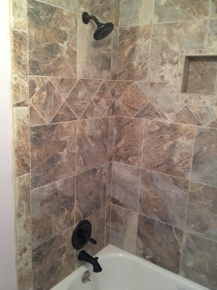 Modern bathroom in Denver with a drop-in tub, a shower/bathtub combo, green tile and porcelain tile.