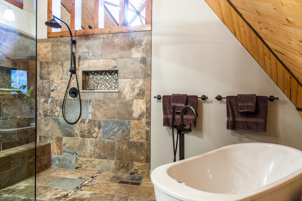 Mid-sized mountain style master multicolored tile and porcelain tile porcelain tile and multicolored floor freestanding bathtub photo with a vessel sink, shaker cabinets, quartz countertops, a one-piece toilet, gray walls and dark wood cabinets
