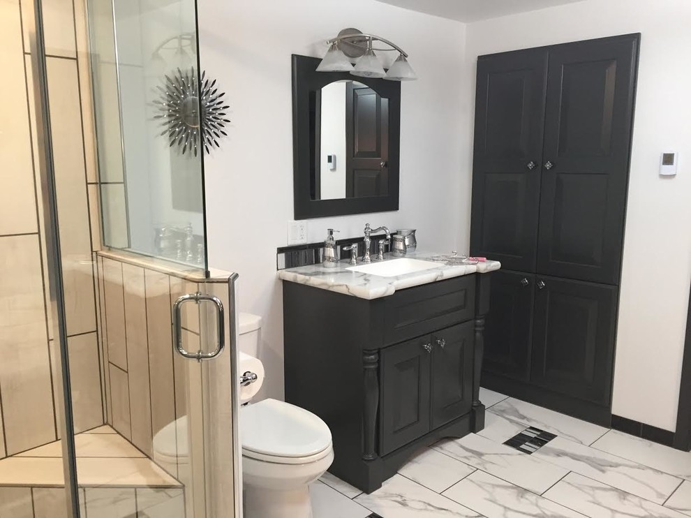 Photo of a large contemporary 3/4 bathroom in Other with raised-panel cabinets, grey cabinets, a corner shower, grey walls, porcelain floors, an undermount sink, laminate benchtops, multi-coloured floor and a hinged shower door.