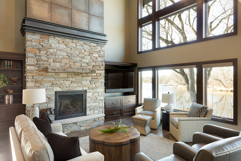 Photo of a country family room in Other with beige walls, dark hardwood floors, a standard fireplace, a metal fireplace surround and a built-in media wall.