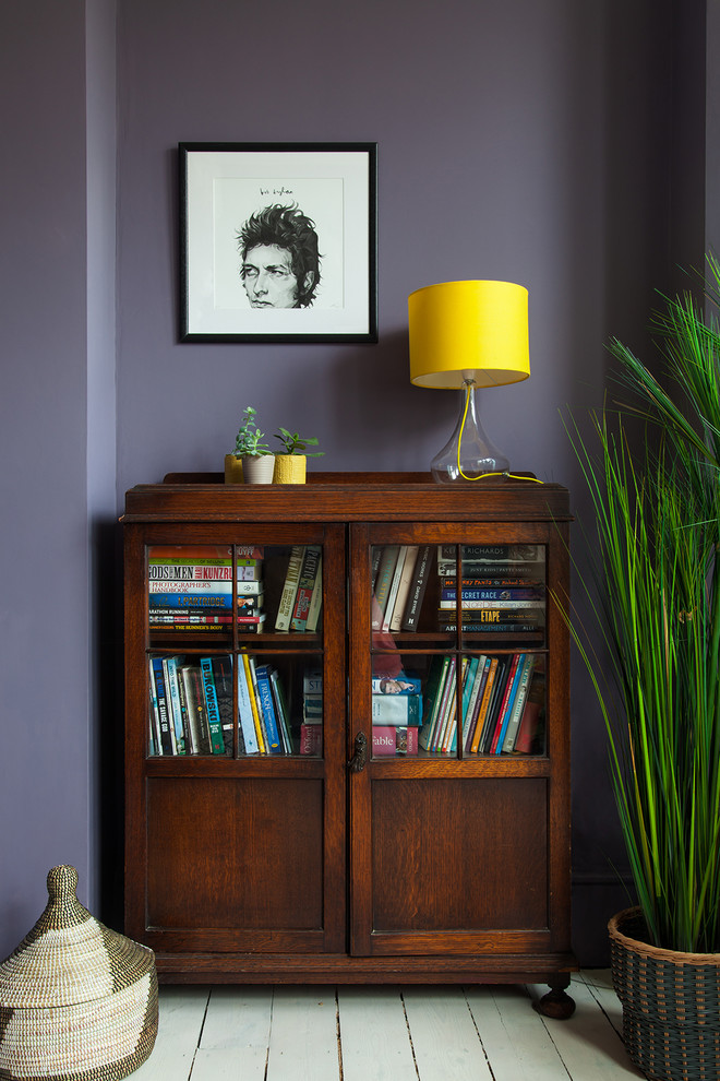 Design ideas for a large eclectic study room in London with purple walls, painted wood floors, a standard fireplace, a plaster fireplace surround, a freestanding desk and white floor.