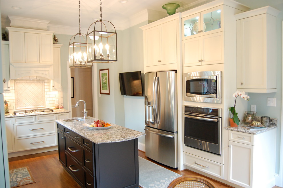 Eat-in kitchen - transitional u-shaped eat-in kitchen idea in Raleigh with an undermount sink, recessed-panel cabinets, white cabinets, quartzite countertops, white backsplash, subway tile backsplash and stainless steel appliances