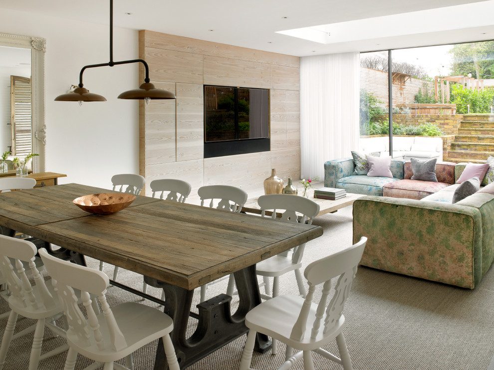 Photo of an expansive contemporary kitchen/dining combo in London with beige walls, light hardwood floors, no fireplace and beige floor.
