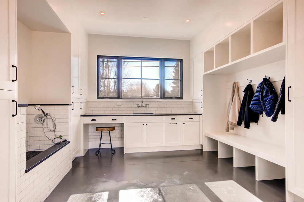This is an example of a country laundry room in Denver with white cabinets and shaker cabinets.