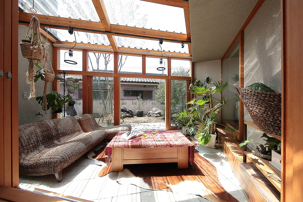 Photo of an asian sunroom in Other with a skylight and grey floor.