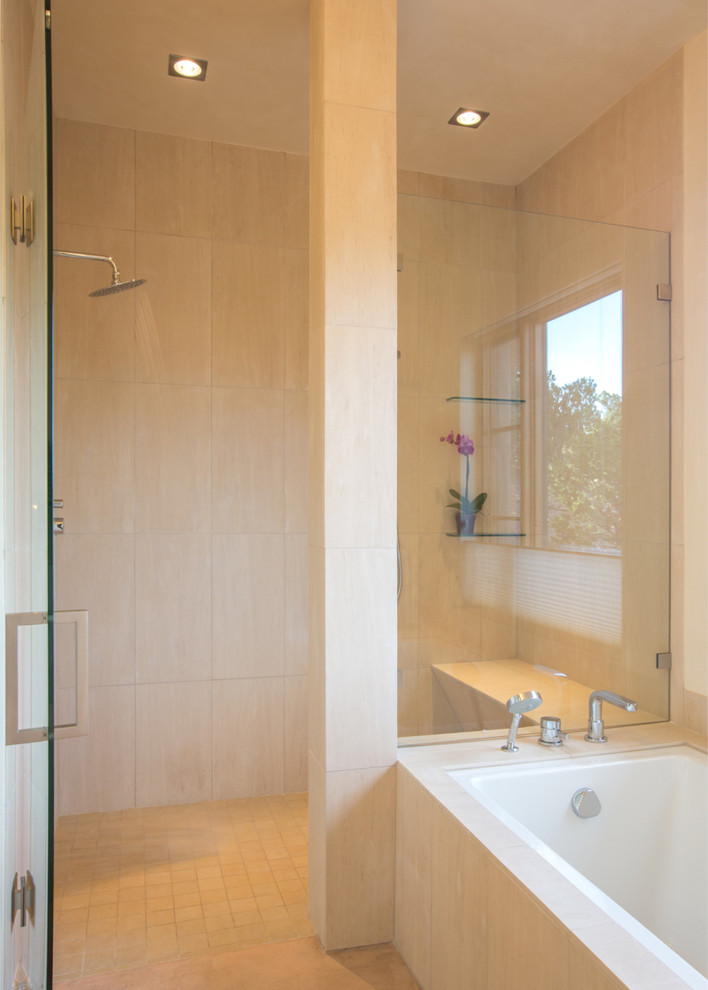 Photo of a large asian master bathroom in Albuquerque with a corner shower, beige tile, stone tile, beige walls, concrete floors and an undermount tub.